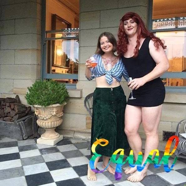 transgender and woman posing with glass of wine transgender and woman posing with glass of wine