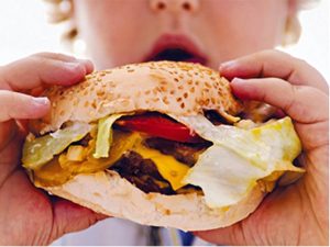 Woman eating hamburger